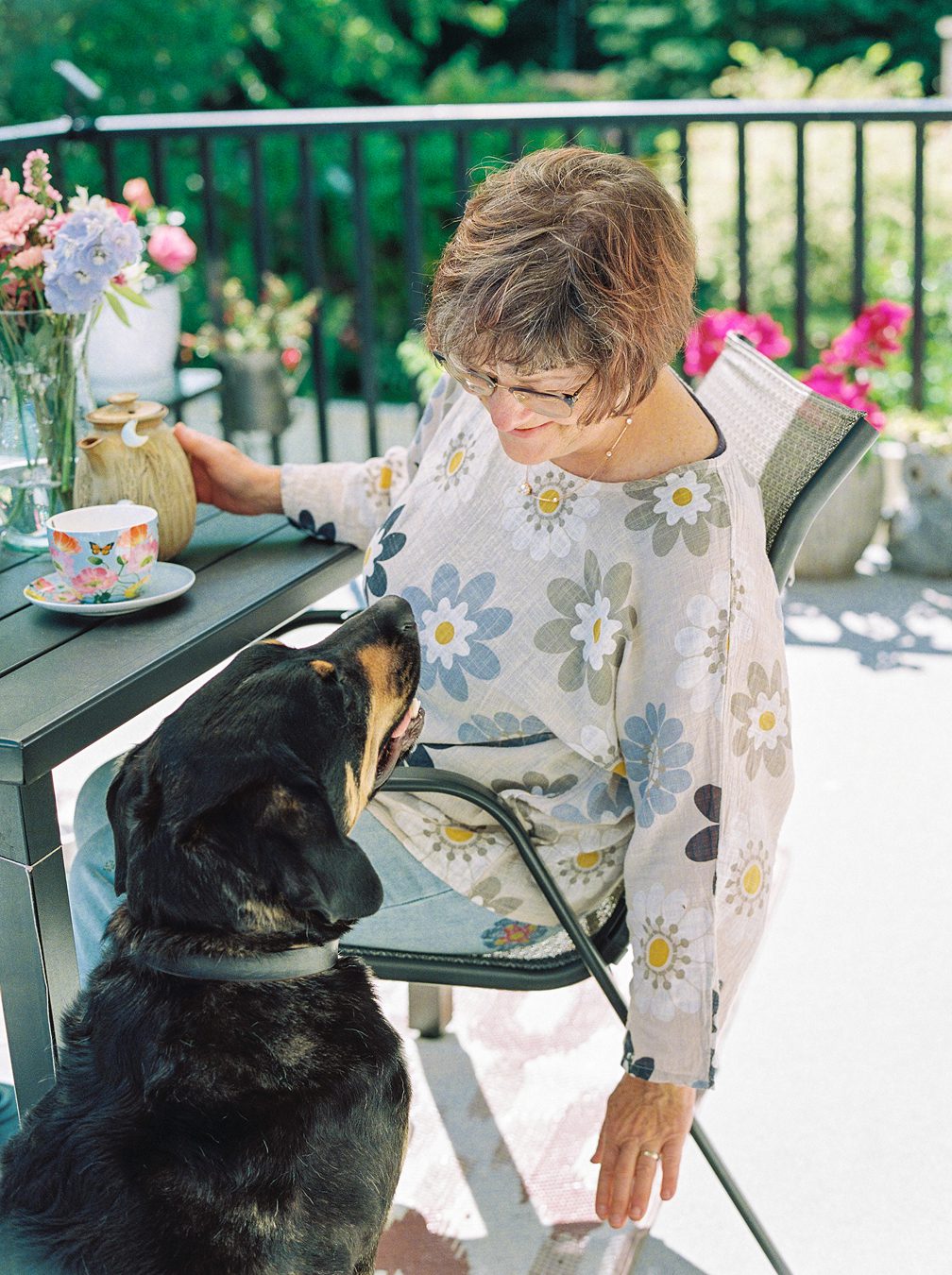 Christine, owner of Transforming in Hope, sits with her dog Gibson, ready to connect with you for a free consultation call.